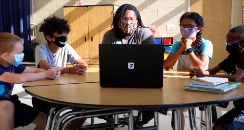 Teacher with four students at Y academy virtual learning support program