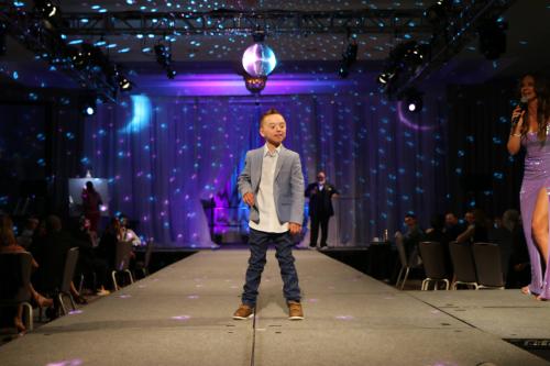 Challenger athlete Bennett Fischer on the runway at the 16th Annual Challenge Your Fashion presented by Pro Athlete.
