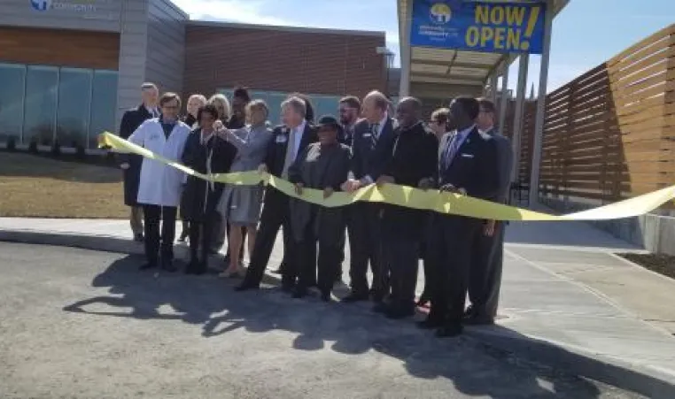 Leaders from University Health/Truman Medical and the YMCA of Greater Kansas City gather outside new medical center for a ribbon cutting.