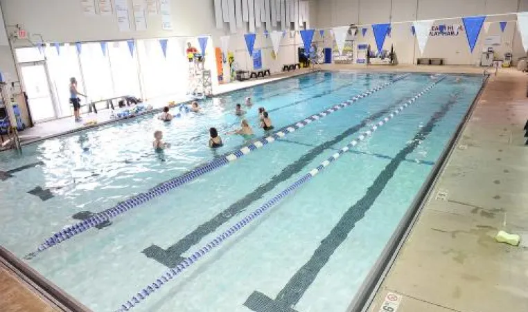 Angled view of an indoor pool with swimming lanes. 