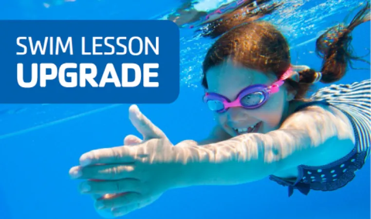 Young girl swimming under water with goggles on. 