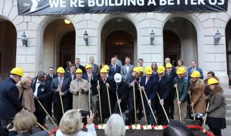 Project leaders gather with shovels to break ground at the new Kirk Family YMCA site.