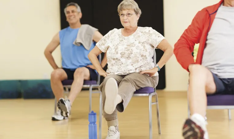 Active Older Adults performing active fall prevention exercises in Kansas City YMCA group class.