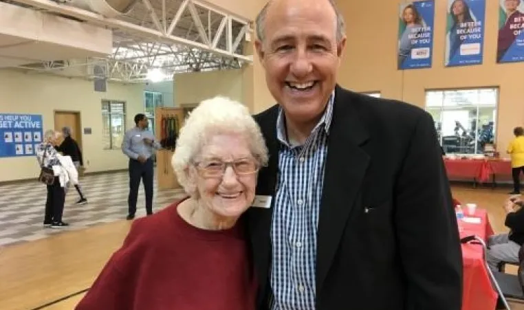 Thelma McDonnell smiles for a photo with David Byrd, Greater Kansas City YMCA President and CEO, at her 101st birthday celebration. 