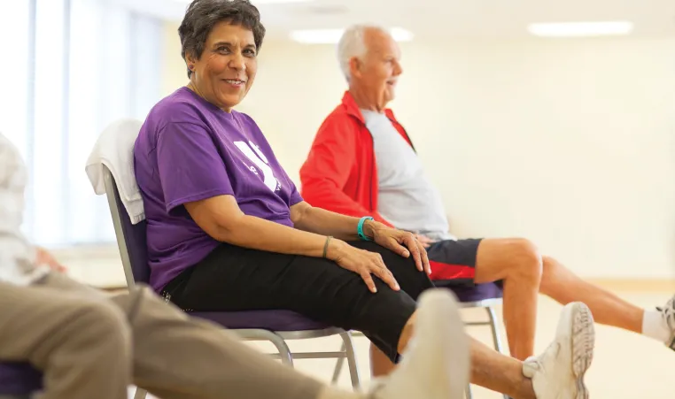 Active Older Adults preform exercises while seated in a Greater Kansas City YMCA.