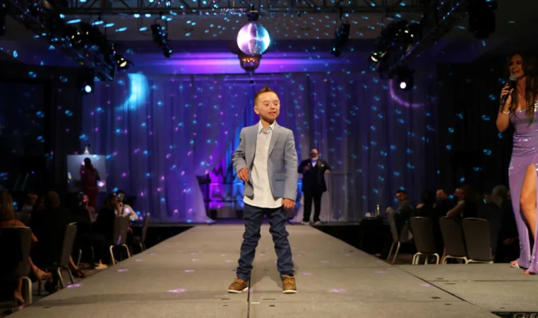 Challenger athlete Bennett Fischer on the runway at the 16th Annual Challenge Your Fashion presented by Pro Athlete.