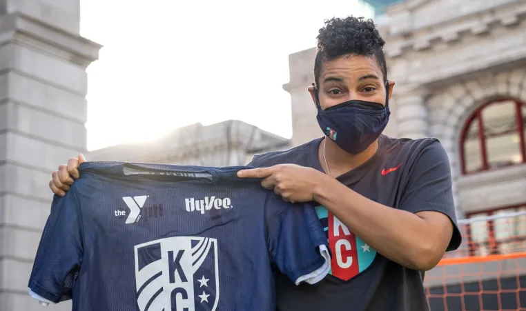 KC Current Goalkeeper Adrianna Franch holds the YMCA KC Current youth soccer jersey.