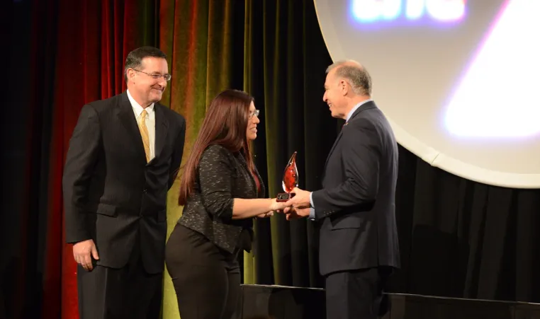 John Passanisi, Chief Volunteer Officer, and John Mikos, Greater Kansas City YMCA President and CEO, handing awards to volunteer award recipient.