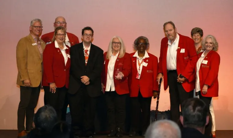 The Kansas City Chiefs Red Coaters accept an award on stage at the 2023 Spirit of Service Awards.