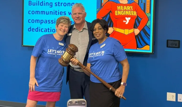 Photo of outgoing Chief Volunteer Officer Dr. Michelle Robin, President and CEO Mark Hulet, and Incoming Chief Volunteer Officer Dr. Andrea Hendricks. Hendricks is holding a large gavel signifying the change in Board of Directors leadership.