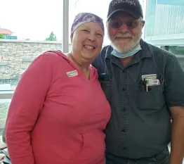 image of cancer survivor and her husband coach smiling together