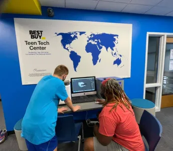 Mentor and teen collaborating on a computer at the Best Buy Teen Tech Center