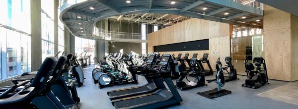 Rows of cardio equipment with suspended walking track above at the Kirk Family YMCA