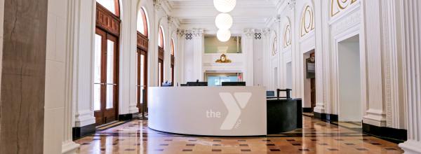 Lobby and welcome center at the Kirk Y, showing restored floor, ceiling and archways from former Lyric Theatre building