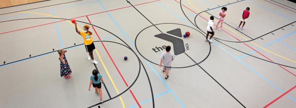 Overhead view of the gym at the Kirk YMCA while several kids play 