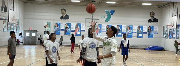 Nicky Lopez tosses a basketball with participants in Catch Success program