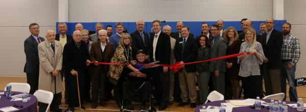 Donors and supporters cut the ribbon on the Atchison YMCA/Cray Community Center December 6, 2017. Bud Cray is in the center, holding the scissors with his daughter Karen Seaberg.