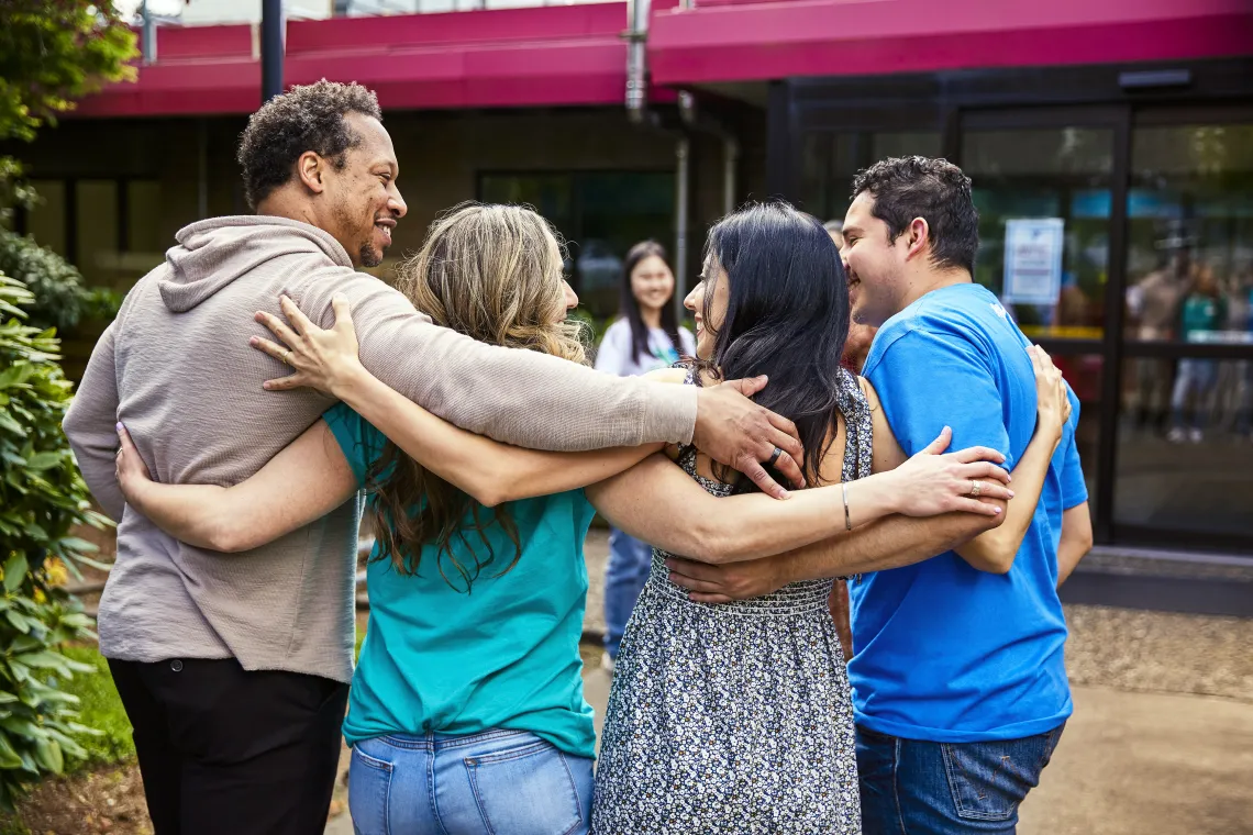 Photo of YMCA members hugging and smiling