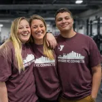 Photo of three members on wellness floor wearing limited edition "Where KC Connects" t-shirt